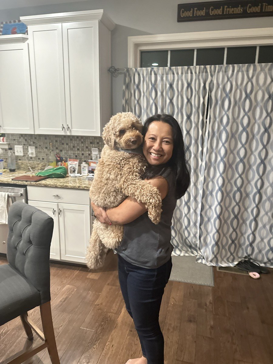 Gigi holding Frank in the kitchen